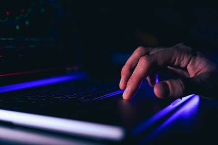 A man typing in his laptop